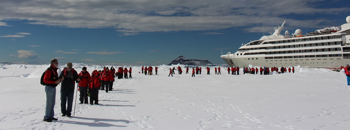 On the ice floe with Cockburn Island in the background. Ponant Antarctic Cruise on Le Soleal